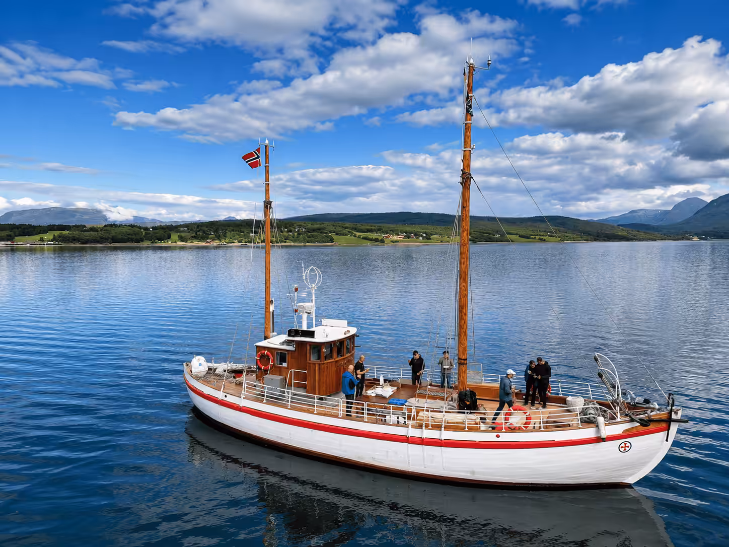 Historic wooden boat M/K Biskop Hvoslef on the fjord